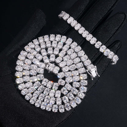 Coiled 7MM moissanite tennis chain showing its wide link structure with its lobster clasp visible