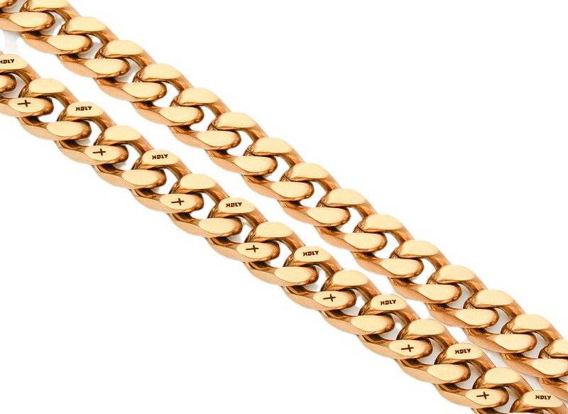 Coiled 10MM 18k gold plated cross Cuban link chain against a white background