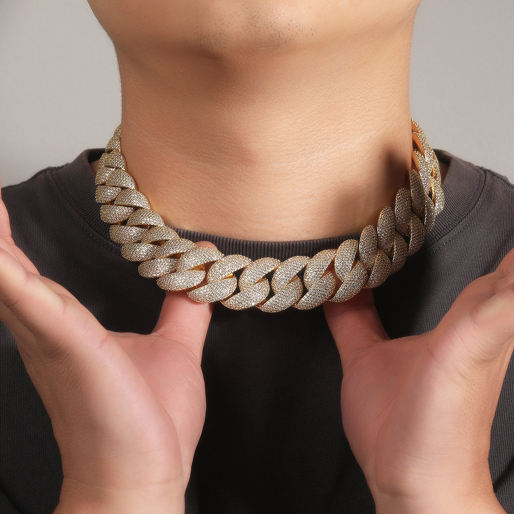 24MM gold Cuban link chain worn around the neck against a neutral background