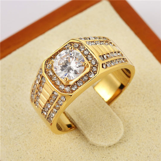 Gold-tone sculpted ring with a clear center stone, halo and ridged wide band, displayed upright