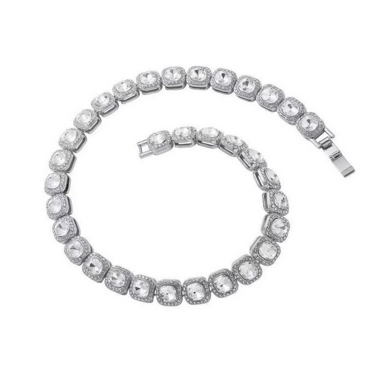 Coiled 10MM white gold tennis chain against a white background with its box clasp visible