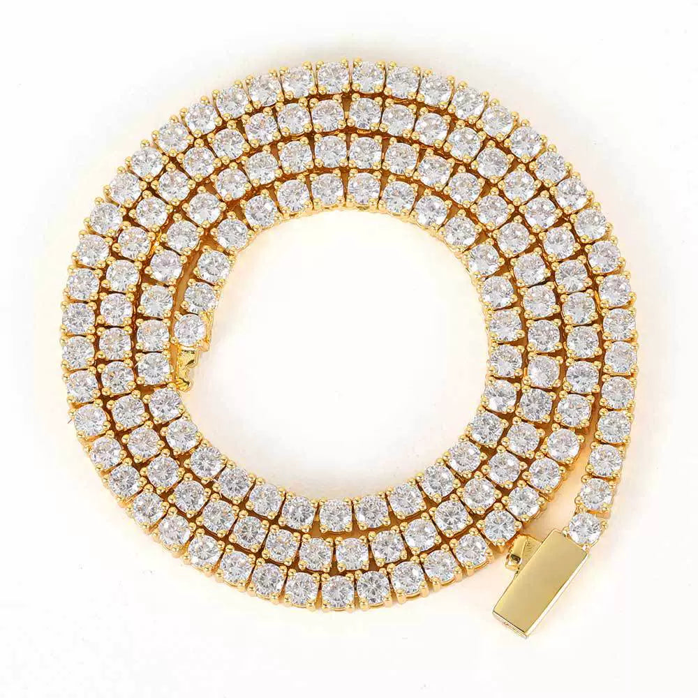 Coiled gold tennis chain against a white background with its box clasp visible