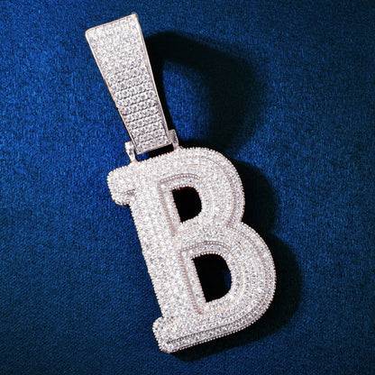 Extreme close-up of the fully iced-out Gold PVD B initial pendant by IceGrind. A waterproof, fade-free initial pendant necklace made with hand-set VVS simulated diamonds.