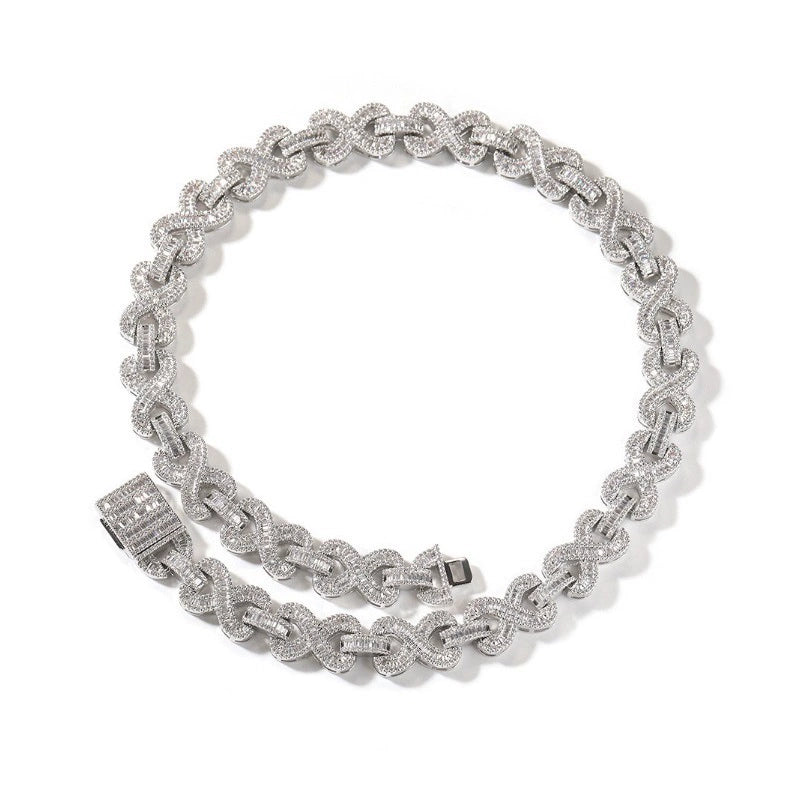 Coiled 16MM white gold infinity link chain against a white background showing its wide link structure with its box clasp