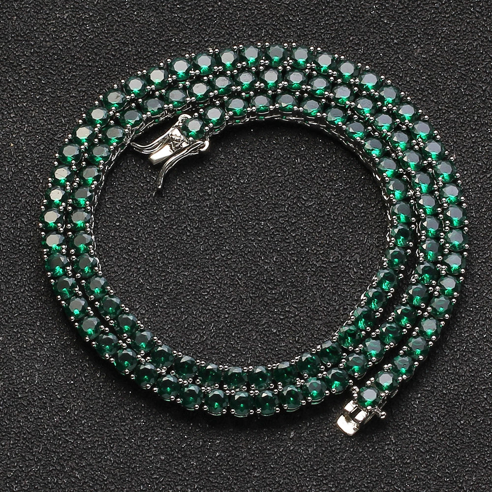 Coiled 4MM white gold tennis chain on a dark textured surface with its box clasp visible
