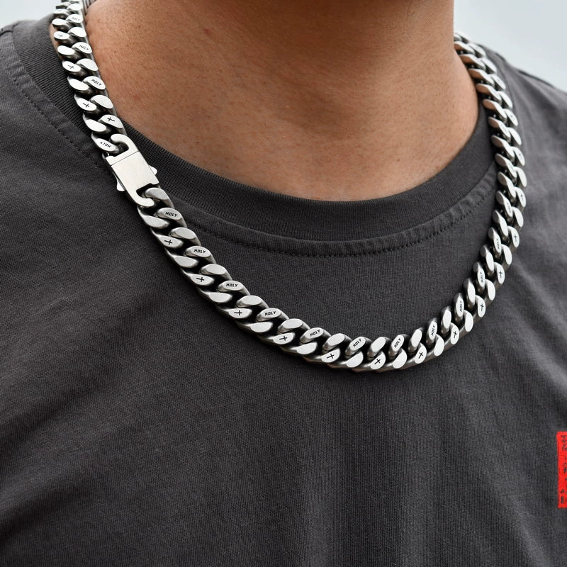 white gold Miami Cuban link chain worn around the neck for fit and style with clasp visible