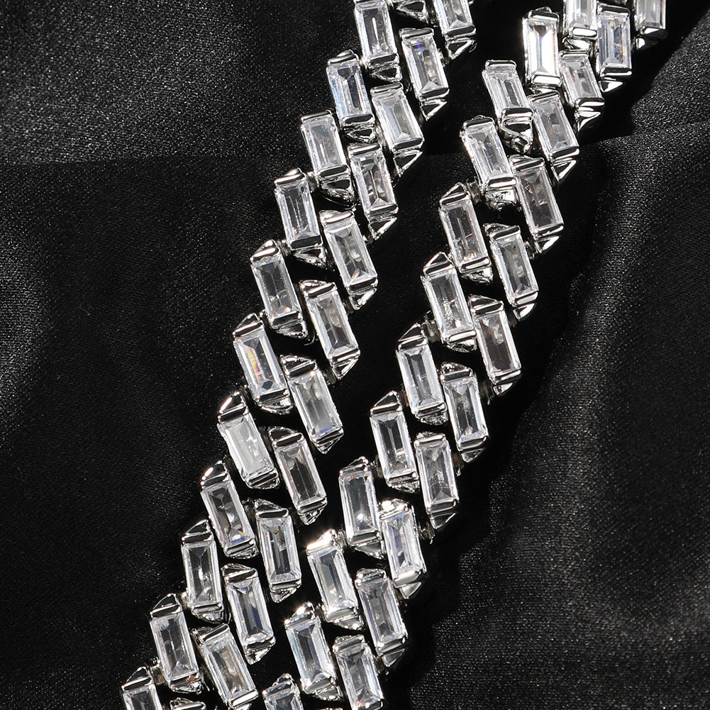 Close-up of 12MM white gold Cuban link chain links laid flat