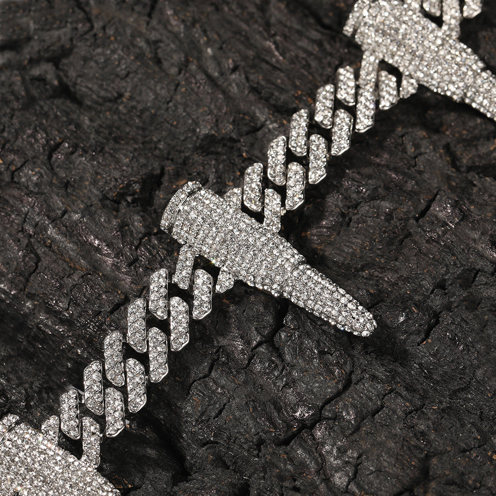 Coiled 12MM white gold Cuban link chain with iced out bullet links on a dark textured surface