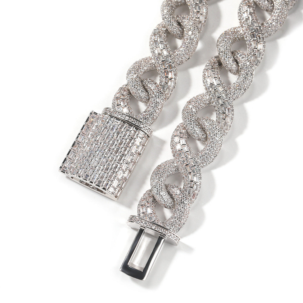 Close-up of Miami Cuban link chain links and box clasp laid flat against a white background