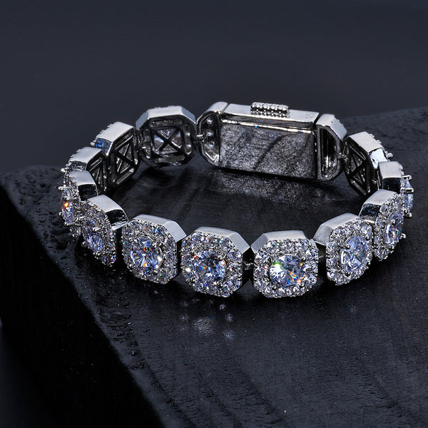 Silver-tone cushion halo link bracelet laid flat with stone-covered surfaces