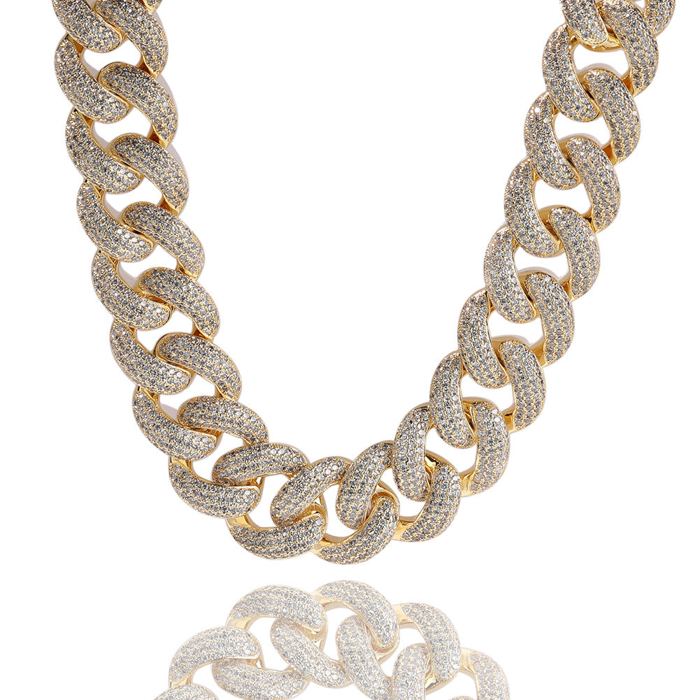 Miami Cuban link chain draped in a U-shape on a white reflective surface