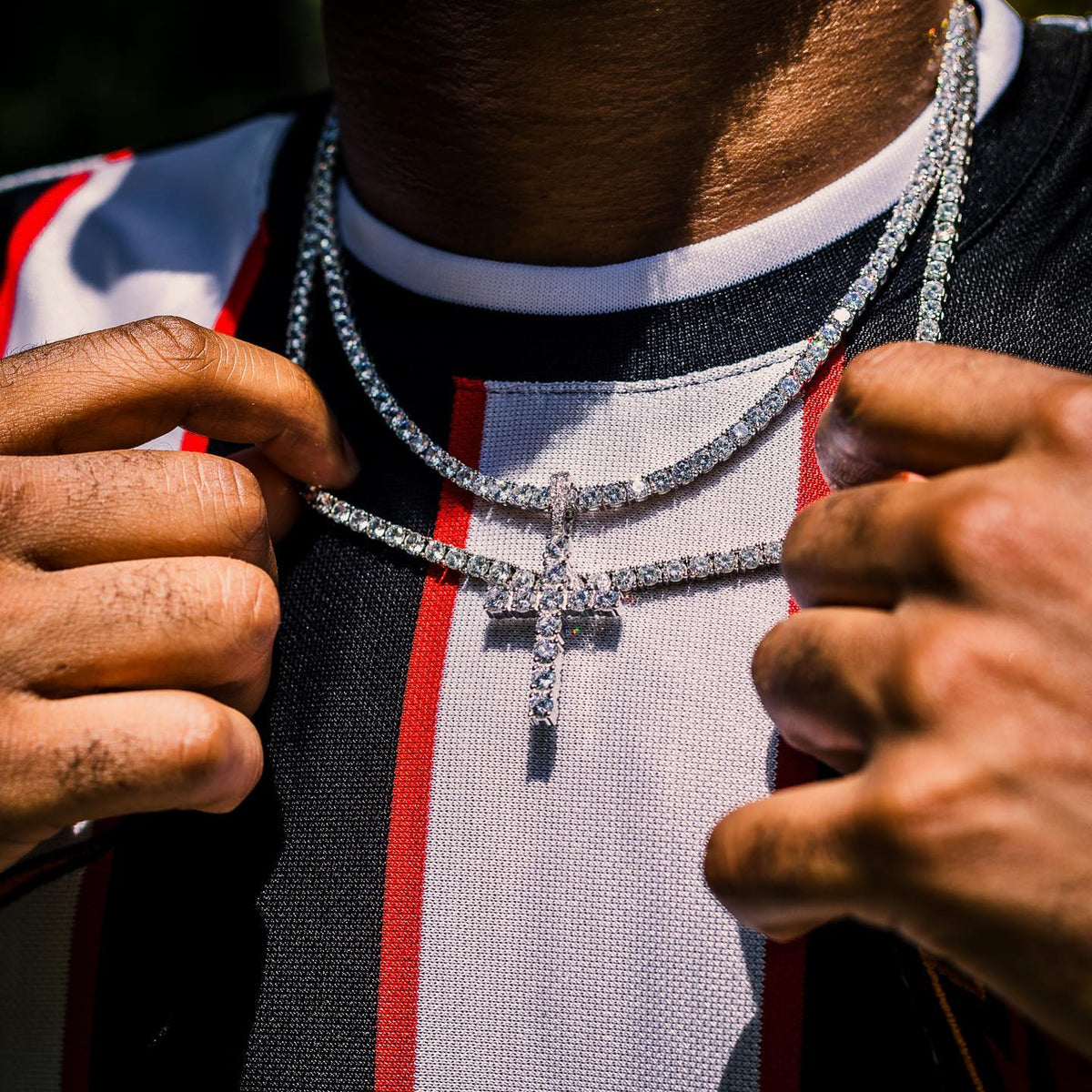tennis chain worn around the neck on a model against a white background