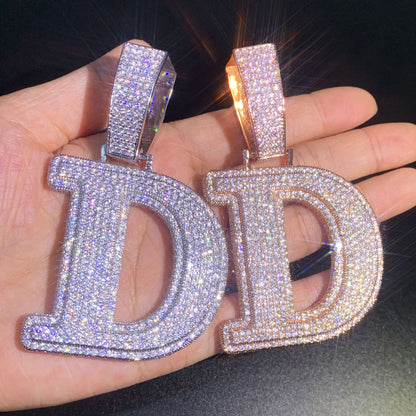 Color comparison of the oversized IceGrind initial pendant. Massive D pendants in silver and rose gold, featuring hand-set simulated diamonds on an 18K PVD-plated base.