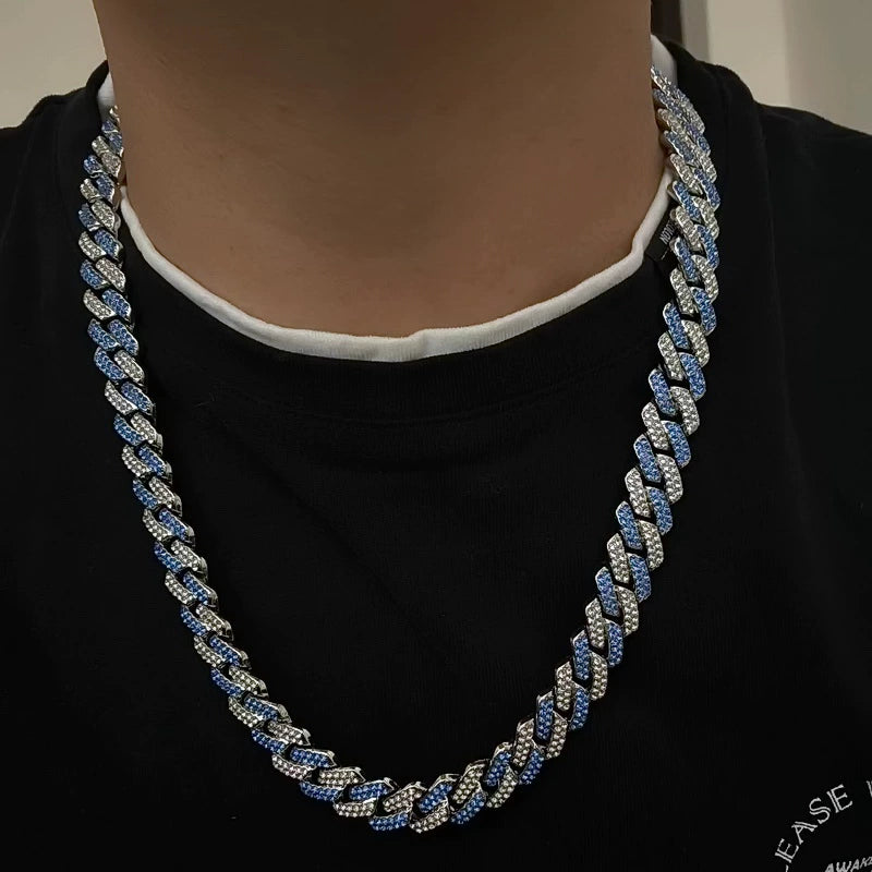 13MM white gold Cuban link chain worn around the neck for fit and style with pave stones visible