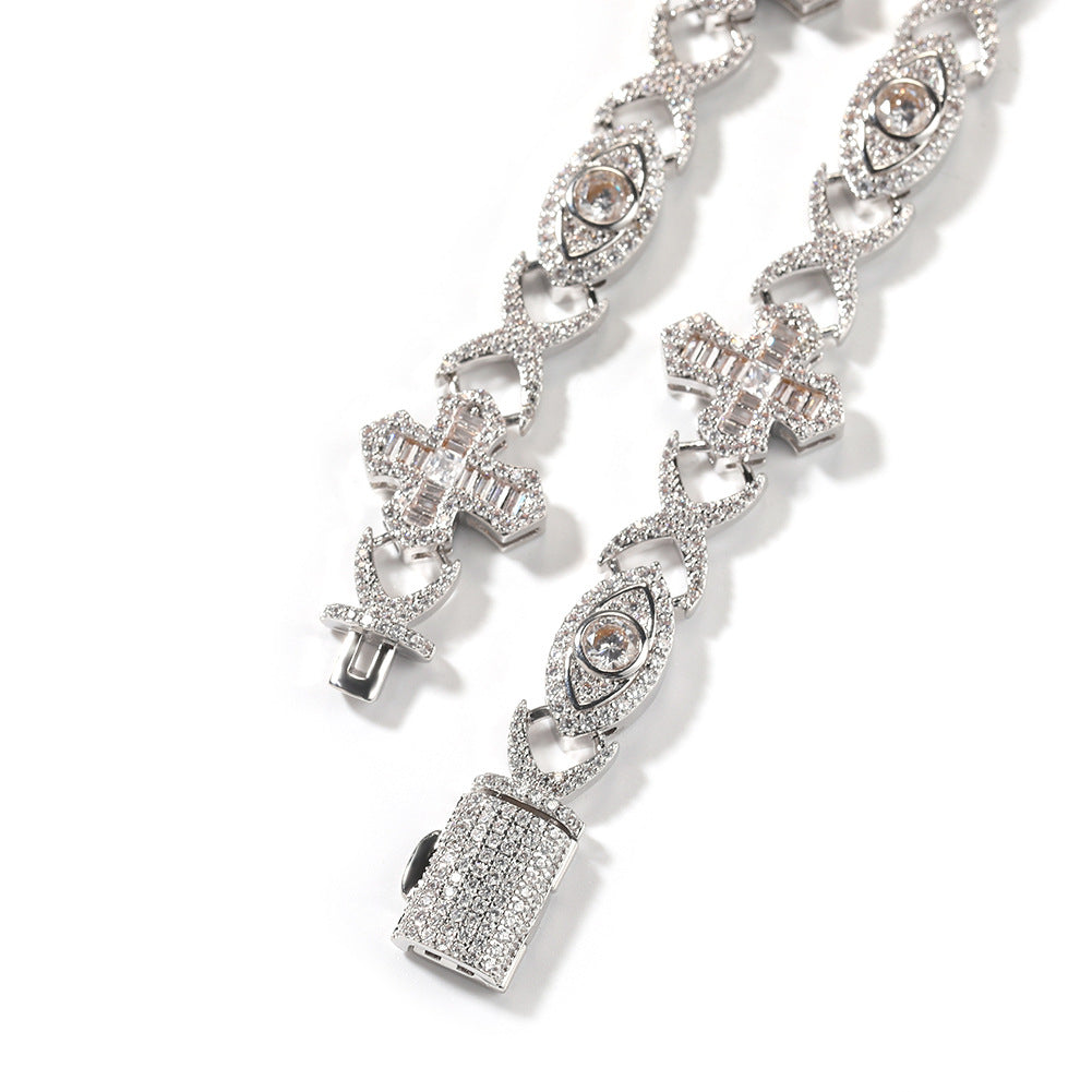 Curved 14MM white gold iced out evil eye cross link chain laid against a white background