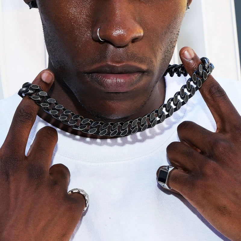 12MM black Cuban link chain worn around the neck against a white background