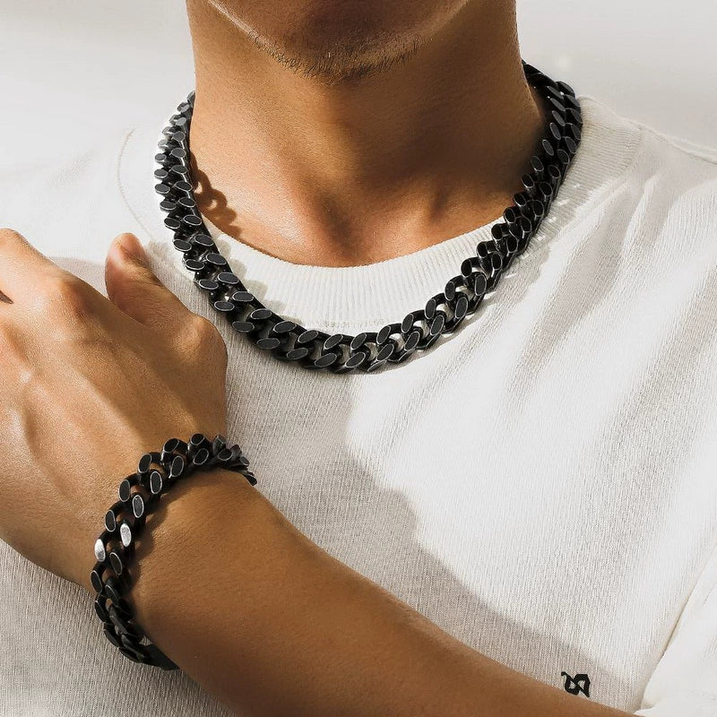 12MM black Cuban link chain shown as a necklace with matching bracelet on the wrist