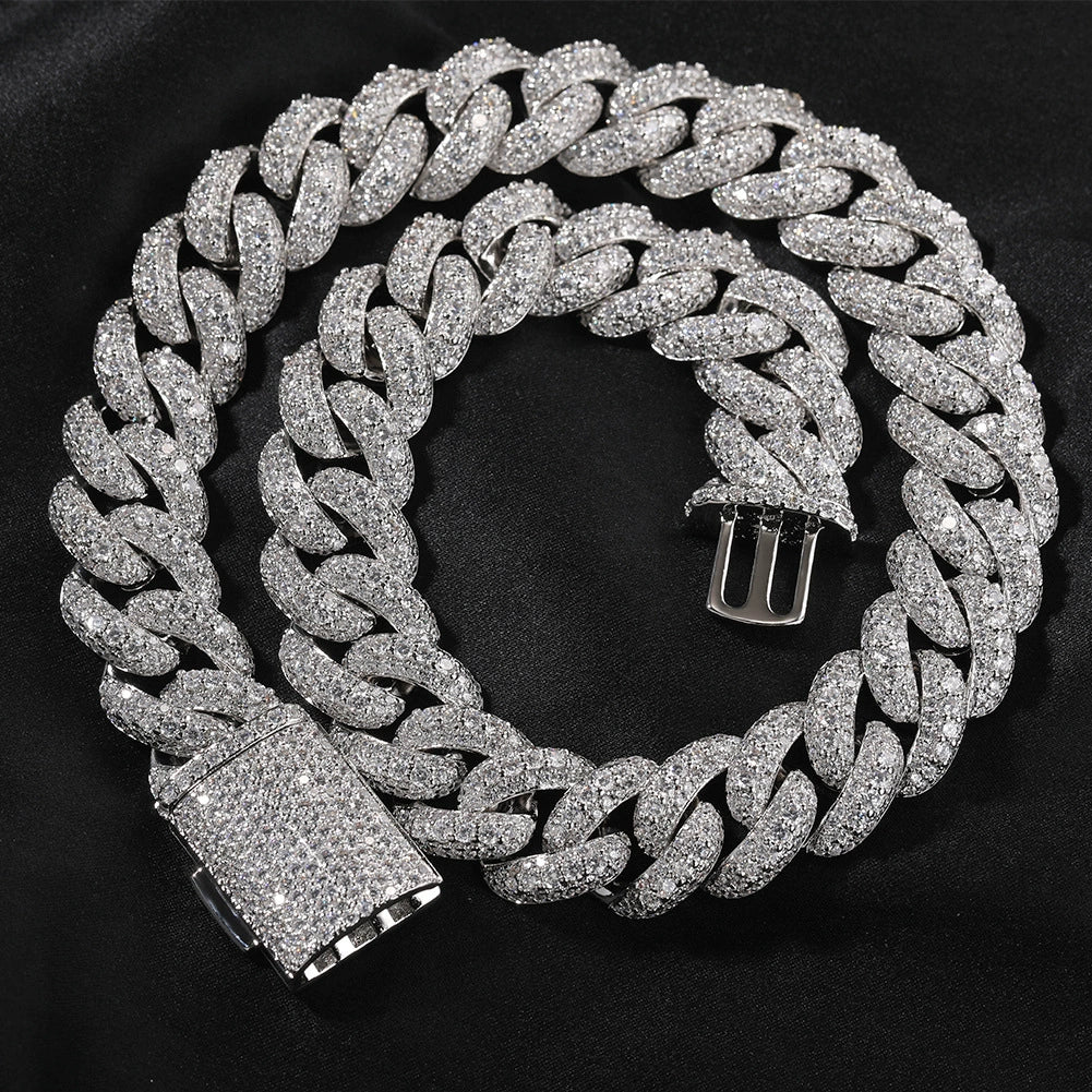 Coiled 18MM white gold Cuban link chain showing its wide link structure with its box clasp visible