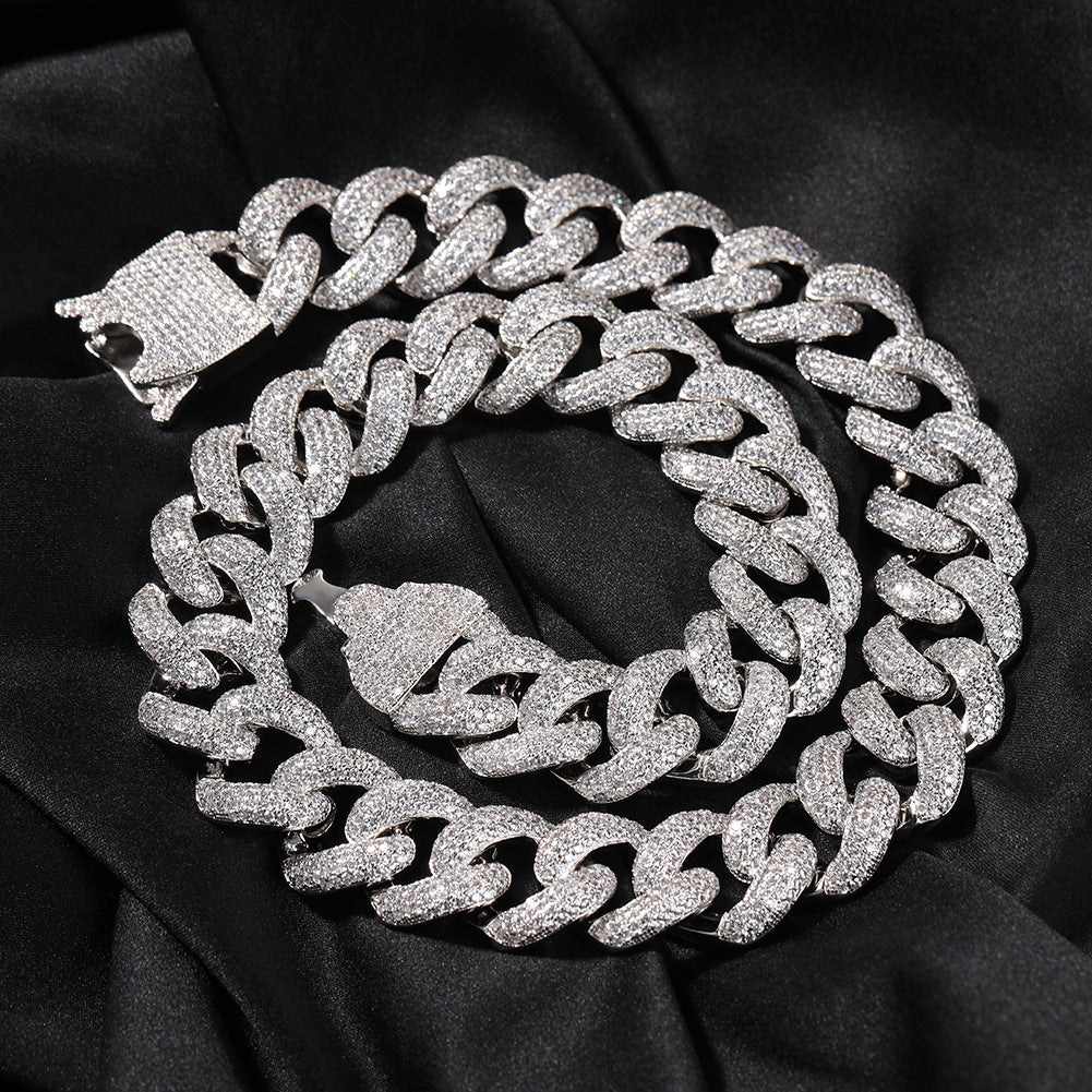 Coiled 20MM white gold Cuban link chain with its box clasp visible