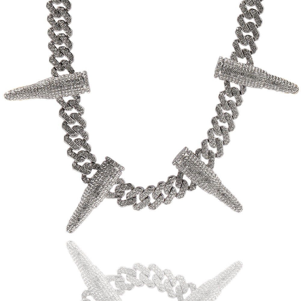 Curved 12MM white gold Cuban link chain with iced out bullet links displayed against a white background with reflection