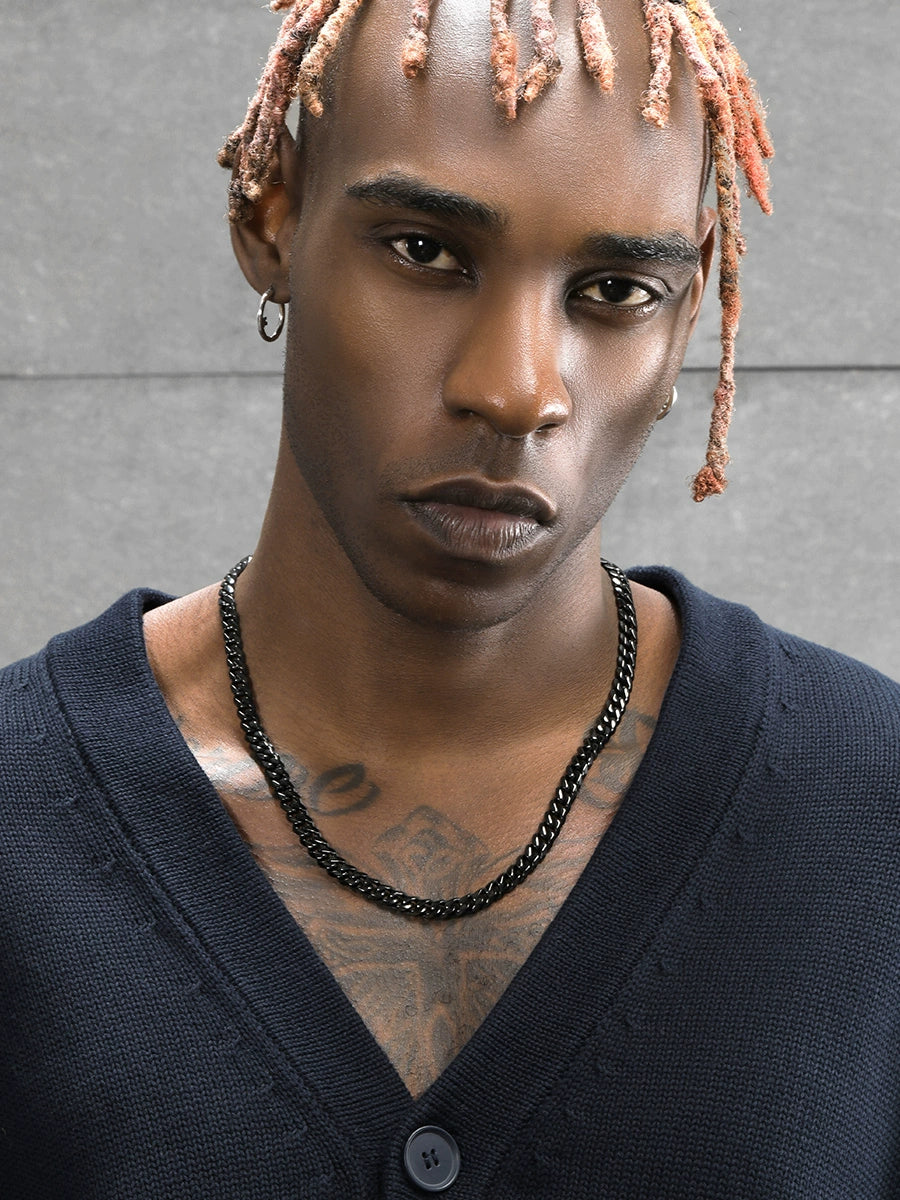 8MM black Cuban link chain worn around the neck on a model showing its high polish finish
