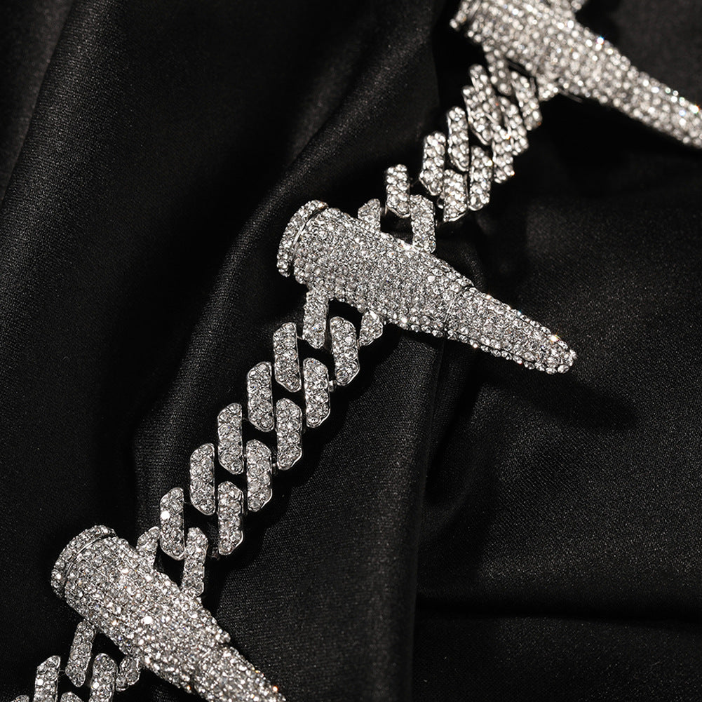 Close-up of 12MM white gold Cuban link chain with iced out bullet links links laid flat