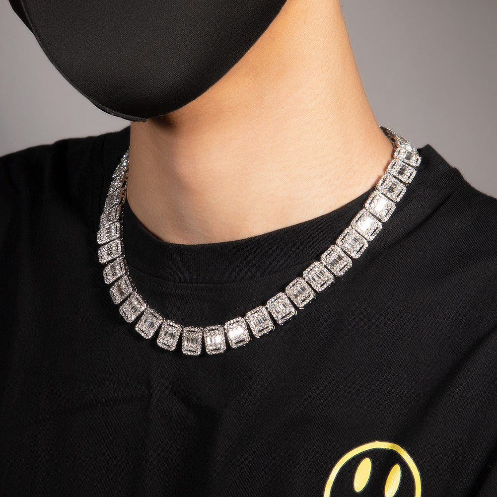13MM white gold tennis chain worn around the neck against a neutral background