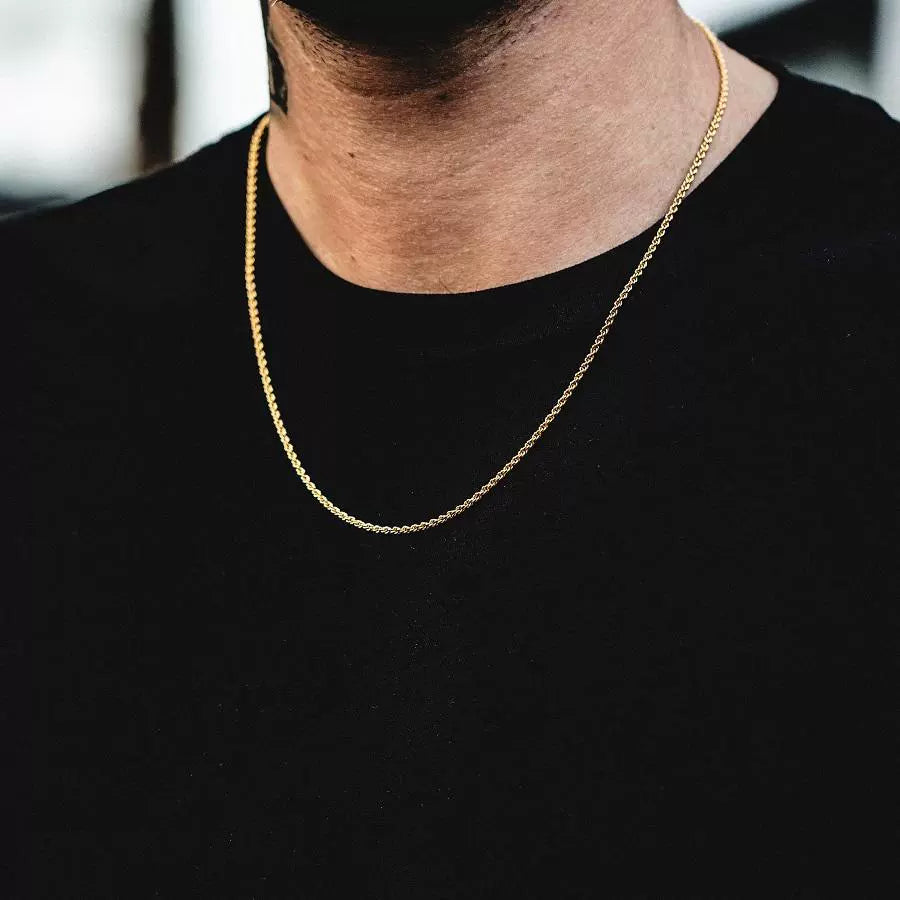 3MM gold rope chain worn around the neck in a neutral blurred scene