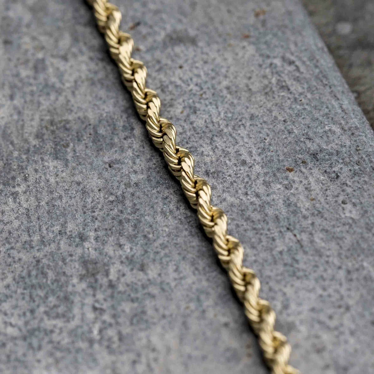 Close-up of 3MM gold rope chain links laid flat