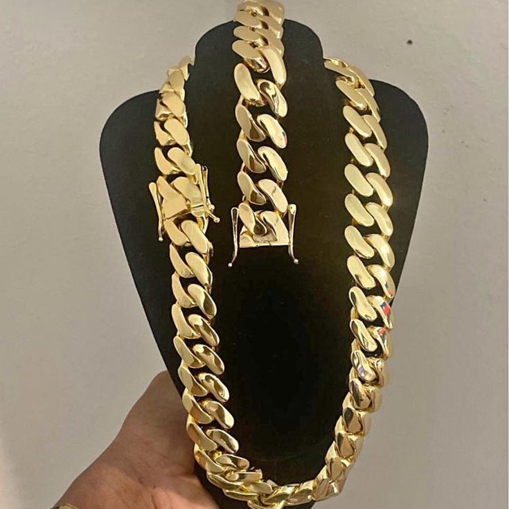 20MM gold Miami Cuban link chain and matching bracelet displayed on a black mannequin