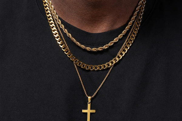 IceGrind gold chain collection featuring layered gold chains and a cross pendant on a Black male model