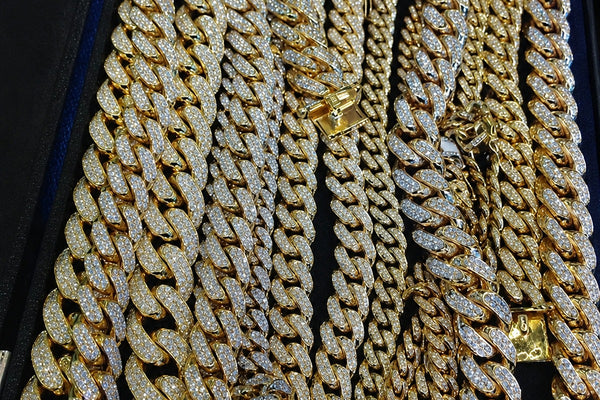 IceGrind gold Cuban link chain collection featuring iced out gold Cuban chains in a luxury jewelry display