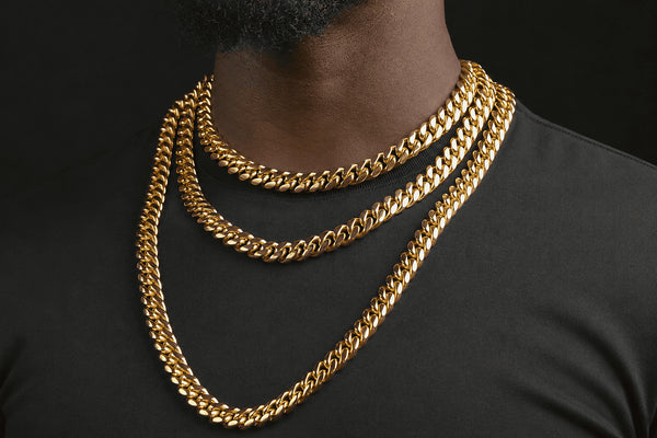 IceGrind gold Miami Cuban link chain collection image with stacked Cuban chains on a dark shirt