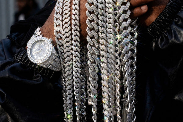 IceGrind silver Cuban link chain collection featuring iced out silver Cuban chains on a Black male model